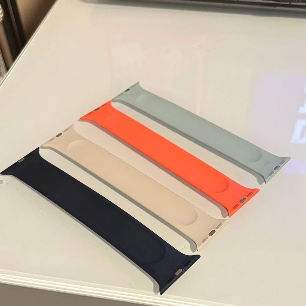 Apple Watch solo bands in Navy, Beige, Orange, and Sage
